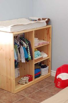 a baby's closet with clothes and toys on it in the corner of a room