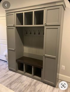 an empty room with gray cabinets and benches