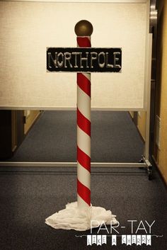 a street sign that has been decorated to look like a pole with the word north pole on it