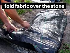 a man is placing fabric over the stone