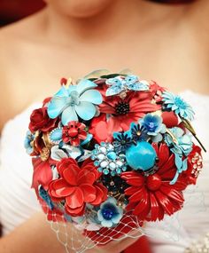 a bridal bouquet with red, blue and white flowers in the shape of a bride's bouquet