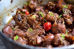 a pot filled with meat and vegetables on top of a table