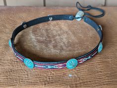 This hitched webbing hatband has a black leather base that is 15mm wide. Copper patina southwest style Conchos accent the band. Ties on with the deertan lace, slide the deer antler bead bead up to "tighten and tie 2 knots in the lace to secure the band. 23" long. Looks great on both palm and felt hats. Hat not included. Southwestern Adjustable Hat Band With Concho, Adjustable Southwestern Hat Band With Concho, Bohemian Adjustable Concho Hat Bands, Bohemian Concho Hat Bands Adjustable, Western Adjustable Hand-tooled Hat Bands, Adjustable Bohemian Concho Hat Bands, Traditional Adjustable Jewelry For Rodeo, Antler Beads, Desert Moon