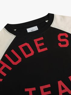 Premium tee crafted from soft, lightweight fabric. Rhude Sail Team jersey graphic showcased on the front. Features a comfortable and relaxed custom Rhude fit. The stripe design on the sleeves adds a sporty touch to this classic short sleeve.    100% COTTON JERSEYDRY CLEAN ONLYWE RECOMMEND TAKING YOUR STANDARD SIZE Film Gift, Swimwear Dress, Team Jersey, Raglan Tee, Mens Tee Shirts, Full Zip Hoodie, Stripes Design, Mens Tees, Lightweight Fabric