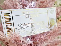 a pink christmas tree with a white and gold ticket