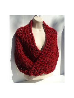 a crocheted red scarf on a mannequin