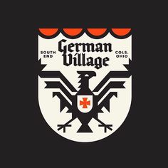 the german village logo with an eagle on it's chest and two arrows in the middle