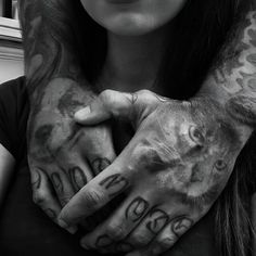 a woman with her hands covered in tattoos