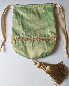 Handmade Regency Drawstring Reticule in colour and decoration of your choice.  If ordering a dress from myself I can make you a reticule to match with the same fabric and accessories (braiding, ribbon, beading, sequins etc) that are used to make you dress. Handmade Beige Pouch Potli Bag, Elegant Green Potli Bag For Festivals, Traditional Green Pouch Potli Bag, Traditional Green Potli Pouch Bag, Green Pouch Potli Bag As Gift, Green Pouch Potli Bag For Gift, Handmade Green Shoulder Bag For Weddings, Handmade Green Shoulder Bag For Wedding, Handmade Green Bag For Wedding