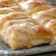 a close up of some kind of pastry on a glass plate with white icing