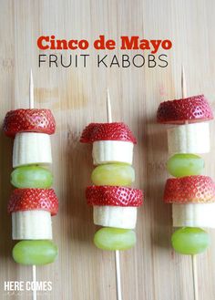 fruit kabobs are arranged on skewers with strawberries and banana slices