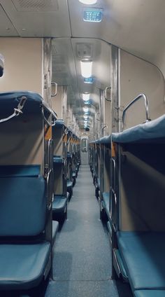 an empty train car with blue seats and no one in the room or on the floor