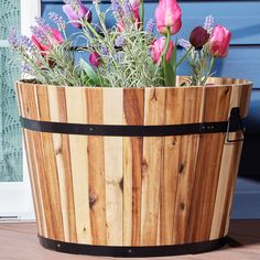 a wooden bucket filled with lots of flowers