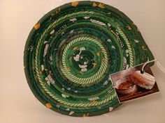 a green and white plate sitting on top of a table next to a magazine cover