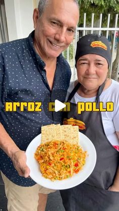 a man and woman holding a plate of food with the caption arroz can pollo