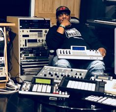 a man sitting in front of sound mixing equipment