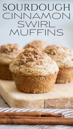 two muffins sitting on top of a cutting board with cinnamon crumbs