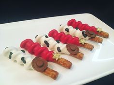 some kind of dessert on a white plate with red, black and white icing