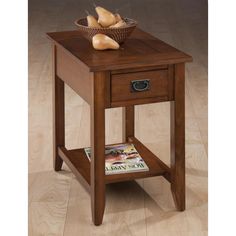 an end table with a magazine on it and some bread in a basket next to it