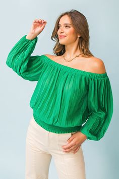 A solid woven top featuring accordion pleats, and elasticized off-the-shoulder neckline, long bishop sleeves, and a wide smocked waistband. Details Self: 100% polyester Size & Fit - Model is 5`8" and wearing size Small - Measurements taken from size Small - Length: 15" Chic Green Blouse For Night Out, Trendy Green Blouse For Night Out, Green Stretch Blouse For Night Out, Stretch Green Blouse For Night Out, Chic Non-stretch Green Blouse, Solid Blouse For Night Out In Spring, Solid Color Blouse For Night Out In Spring, Green Tops, Woven Top