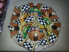 there is a plate that has cookies on it with dogs and checkered flags in the middle