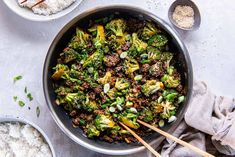 a pan filled with broccoli and rice next to other dishes