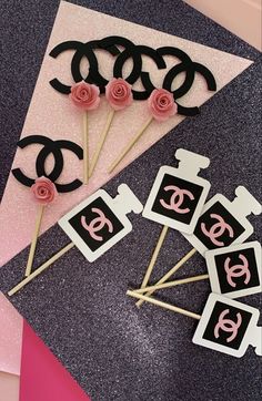 pink and black cake toppers with roses on them