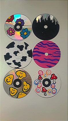 six cds with different designs on them