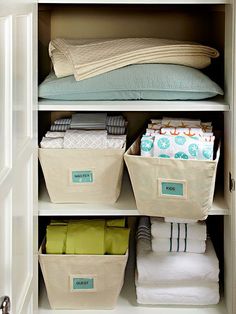 an organized closet with linens, blankets and other items