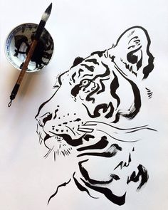 a drawing of a tiger next to a paintbrush