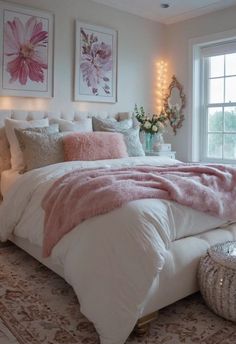 a bed with pink and white pillows in a bedroom