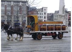 a horse pulling a cart with barrels on it