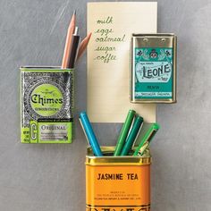 an assortment of teas and pencils in a tin