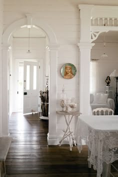 a dining room with white walls and wooden floors