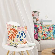 a white chair with colorful pillows on it