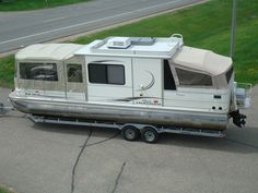 a small boat is parked on the side of the road