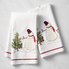 two white towels with snowmen on them