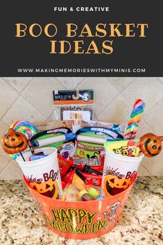 an orange bucket filled with halloween treats on top of a counter