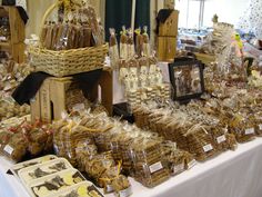 there are many items on the table for sale at this event, including breads and candies