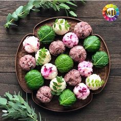 a plate filled with different types of food on top of a wooden table next to green leaves