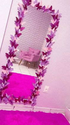 there is a mirror with purple butterflies on it and a pink rug in the corner