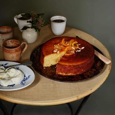 a cake on a table with some cups and saucers