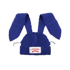 a blue knitted hat with ears on the front and back, sitting up against a white background