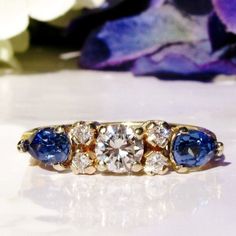 "An exquisite vintage and blue sapphire engagement ring perfect as the \"something old, something blue\" for your wedding! This estate ring was too beautiful to pass by and I thought it would make a stunning wedding band and/or unique engagement ring like many of the young couples today are wearing. This well made ring has such pretty quality stones that we decided to get an appraisal by an independent GIA Graduate Gemologist and the certificate of appraisal is included with this ring. The beaut Blue Cluster Ring With Prong Setting For Anniversary, Heirloom Blue Sapphire Birthstone Ring, Blue Birthstone Cluster Ring For Anniversary, Heirloom Blue Sapphire Ring With Rose Cut Diamonds, Heirloom Blue Birthstone Ring For Promise, Heirloom Blue Birthstone Promise Ring, Vintage Blue Diamond Ring For Wedding, Heirloom Blue Diamond Ring For Anniversary, Classic Blue Birthstone Ring For Wedding