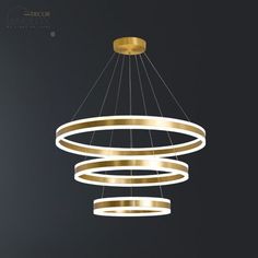 Introducing the Rastaban - Ring-shaped LED Chandelier, a perfect blend of modern simplicity and exquisite design. This opulent lighting fixture is guaranteed to elevate any space, whether it's a luxurious living room or a trendy cafÃ©. Crafted with precision, its sleek ring shape exudes elegance and sophistication. The chandelier is adorned with premium LED lights that emit a warm and inviting glow, setting the perfect ambiance for gatherings and intimate moments. Made with high-quality materials, this statement piece ensures durability and longevity. With its adjustable height feature, it can effortlessly fit any ceiling height. Add a touch of contemporary charm to your surroundings with the Rastaban - Ring-shaped LED Chandelier!Size: 16"+23.5" 16"+23.5"+31.5" Length: 24" 31.5" Fixture Wi Led Chandelier Modern, Circular Chandelier, Luxurious Living Room, Chandelier Brass, Gold Fixtures, Ring Chandelier, Chandelier Lighting Fixtures, Ring Shapes, Black Pendant Light