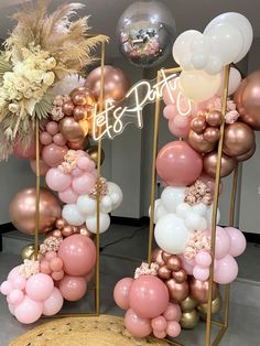 balloons and flowers are arranged in the shape of an arch for a birthday party decoration