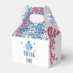 a thank you gift bag with pink and blue flowers on the front, in a white box