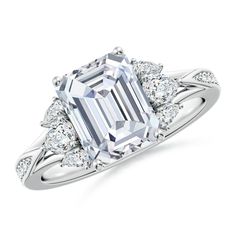 an emerald - cut diamond ring with three stone shoulders