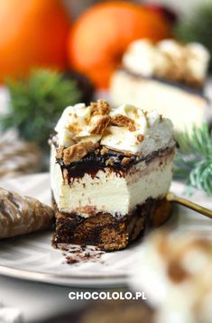 a piece of cake sitting on top of a white plate next to some oranges