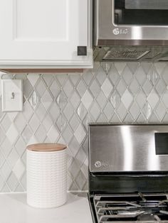 a stove top oven sitting inside of a kitchen next to a microwave and toaster